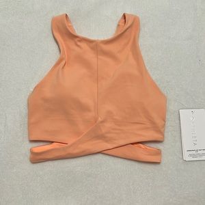 Athleta Conscious Cut Out Crop in a Peach color